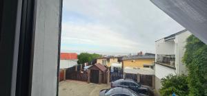 a view from a window of a street with buildings at Apartament 2 pokojowy z widokiem na morze in Sarbinowo