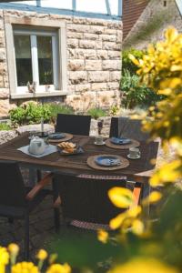 una mesa de madera y sillas con comida. en Ferienwohnung Maierers Schaiere, en Gammesfeld