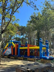 a playground in a park with a play structure at Mobil home 6 à 8 personnes in Piriac-sur-Mer +15 photos
