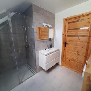 a bathroom with a shower and a sink at Domek pod Skiełkiem in Łukowica +90 photos