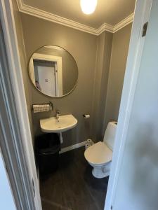 a bathroom with a toilet and a mirror at Vandrarhemmet Åmål in Åmål