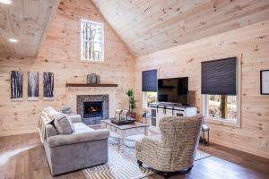 a living room with a couch and a fireplace at Cozy Cabin near Historic Dahlonega Town Square in Dahlonega