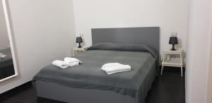 a bedroom with a bed with two towels on it at Ecoflat Casa Vacanze in Lipari