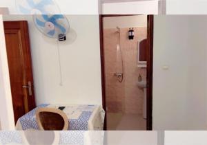 a bathroom with a toilet and a shower in it at Résidence Douce in Dakar +91 photos