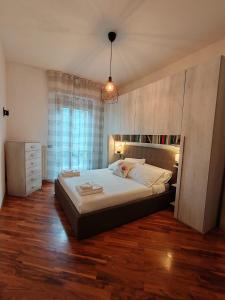 a bedroom with a large bed and a window at Casa Guarducci in Prato