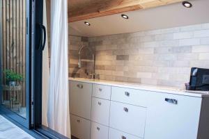 a kitchen with a sink and a counter with cabinets at Casa Mint in Sozopol