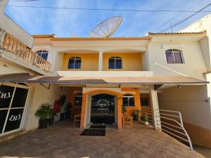 a house with a satellite on top of it at Lady Laura Hotel in Taquarituba