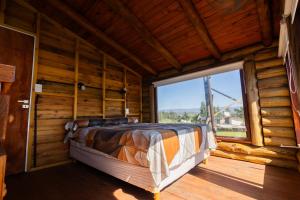 a bed in a room with a large window at Mi lugar en el mundo in Villa Ciudad Parque +56 photos