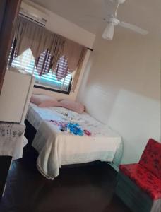 a small bedroom with a bed and a window at Hotel Central in Arroio do Meio +4 photos