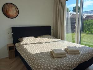 Katil atau katil-katil dalam bilik di Lodge Bosparel Ermelo Harderwijk