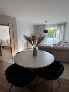 a living room with a table and a couch at Agro Komfort Olecko in Olecko +2 photos