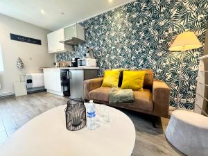 a living room with a couch and a table at La Fleur Bleue - Cozy Apartment in Marck