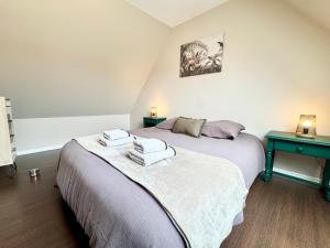a bedroom with two beds and two night stands at La Fleur Bleue - Cozy Apartment in Marck