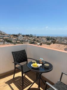 a table and chairs on a balcony with a view at The Piano House in Rincón de la Victoria