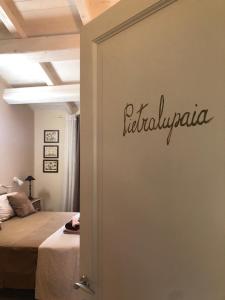 a bedroom with a bed and a sign on the wall at Agriturismo Tenuta Il Molino in Quercianella