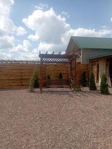 una casa con una valla de madera delante de ella en Озеро Надії, en Ozeryany