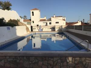 a swimming pool in front of a house at The Piano House in Rincón de la Victoria