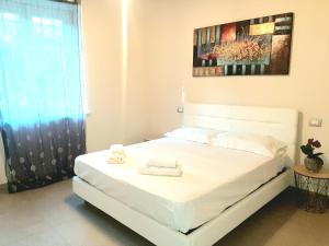 a white bed in a room with a window at Cascina San Giulio in San Damiano dʼAsti