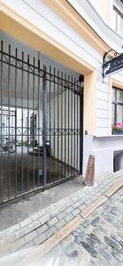 a black gate in front of a building at Wagner's Refuge 1 in Riga