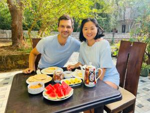 a man and a woman sitting at a table with food at Mashi's Villa in Sigiriya +83 photos