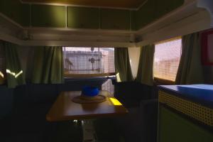 a hat sitting on a table in a train car at Camper Bros - wynajem przyczepy na półwyspie, 10m od plaży, klimatyzacja in Jastarnia +10 photos