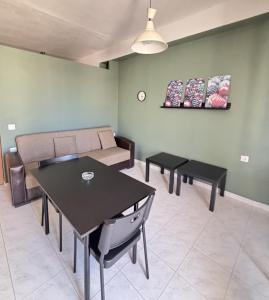 a living room with a table and a couch at City Apartment in Ierapetra