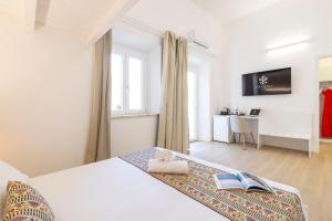 Ένα ή περισσότερα κρεβάτια σε δωμάτιο στο Sant'Elena Rooms
