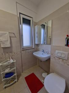 a bathroom with a toilet and a sink at Apartament , White Rocks, Drimadhe in Himare