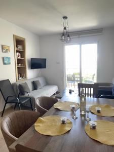 a living room with a table and chairs and a couch at Mythical Sands Resort - Maria in Protaras