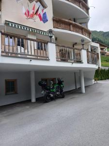 a motorcycle parked in front of a building at Landhaus Paradies Samnaun Spiss in Spiss