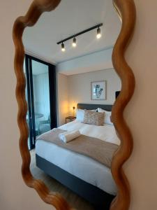 a bedroom with a bed with a large mirror at 308 The Meadows Luxury Deluxe in George +29 photos