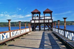 a pier on the water with a couple on it at Agro Komfort Olecko in Olecko