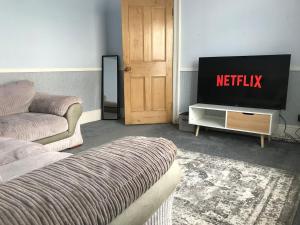 キャッスル・ドニントンにあるCastle Donington 5 Bed House 2 Baths Near EMA And Donington Parkのリビングルーム(テレビ、ソファ付)