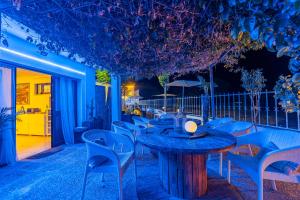 a table and chairs on a patio at night at 4Ever Palace Design&Nature in Alcácer do Sal