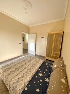 a bedroom with a large bed and a couch at Dar el baraka in Ras El Ma