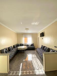 a large living room with couches and a table at Dar el baraka in Ras El Ma