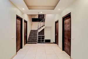 a hallway with doors and stairs in a house at Townhouse Akshay Hotel in Gurgaon