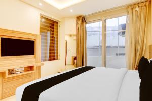 Postel nebo postele na pokoji v ubytování Hotel O Gandhi Hotel