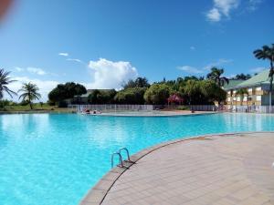 a large pool with blue water in a resort at Karpé diem in Saint-François