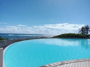 a large swimming pool with a view of the ocean at Karpé diem in Saint-François