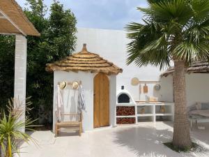 a small house with a wooden door and a palm tree at boracay island in Tala Lakran
