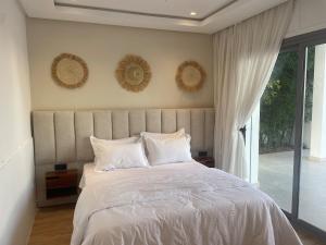 a bedroom with a bed with white sheets and pillows at boracay island in Tala Lakran +15 photos