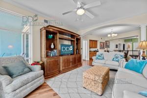 a living room with a couch and a tv at Legacy Tower II 403 in Gulfport