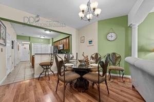 a dining room and kitchen with a table and chairs at Legacy Tower II 403 in Gulfport +11 photos