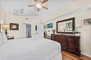 a bedroom with a large bed and a mirror at Legacy Tower II 403 in Gulfport