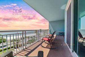 a balcony with chairs and a view of the ocean at Legacy Tower II 403 in Gulfport
