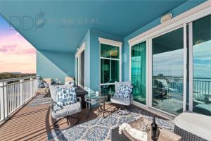 a balcony with two chairs and a table at Legacy Tower II 608 Deluxe in Gulfport