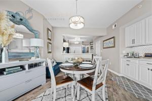 a kitchen and dining room with a table and chairs at Legacy Tower II 608 Deluxe in Gulfport