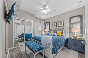 a bedroom with a blue bed and a tv at Legacy Tower II 608 Deluxe in Gulfport