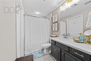 a bathroom with a shower and a toilet and a sink at Legacy Tower II 608 Deluxe in Gulfport +16 photos